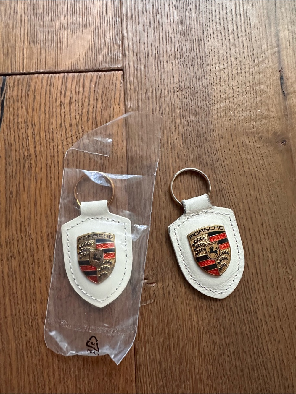 Porsche Design White Leather Crest Keychain Pair with Gold Emblem